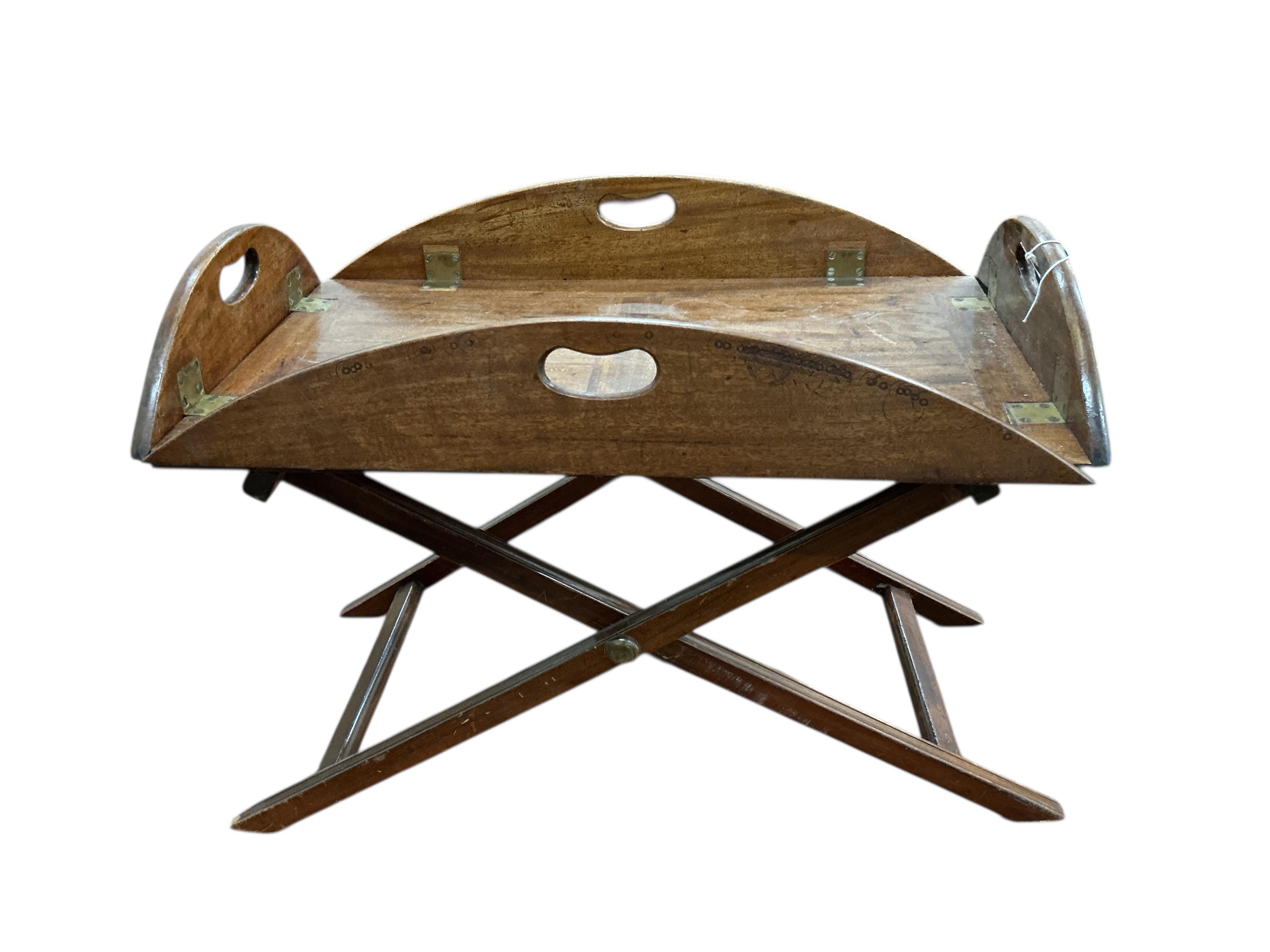 A George III style oval mahogany butler's tray on folding stand, width 70cm, depth 42cm, height 52cm